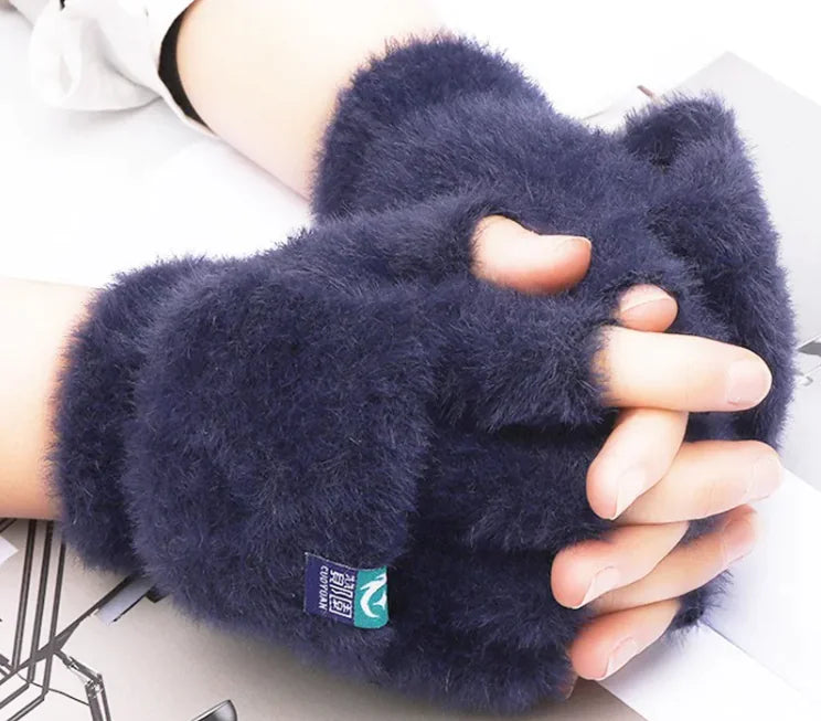 Female fingers flip winter gloves