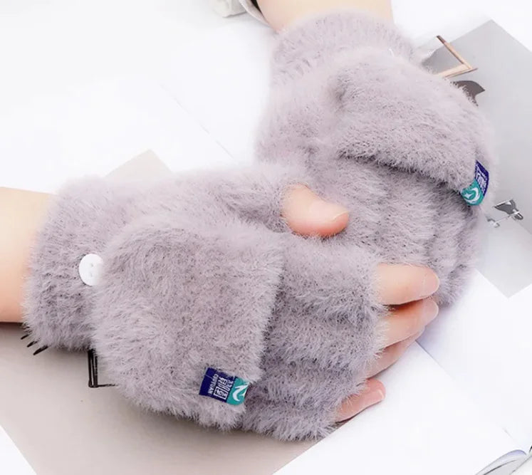 Female fingers flip winter gloves