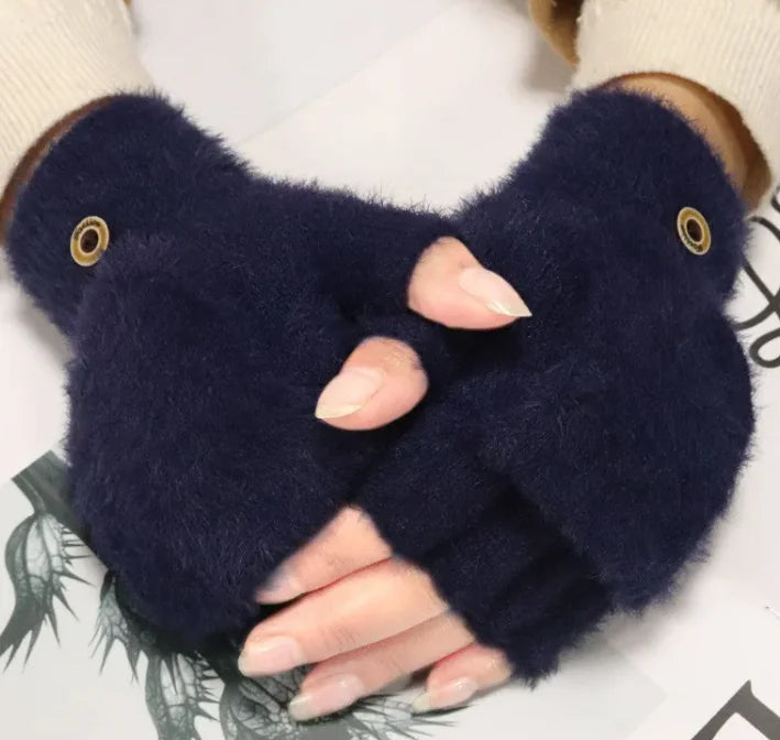 Female fingers flip winter gloves