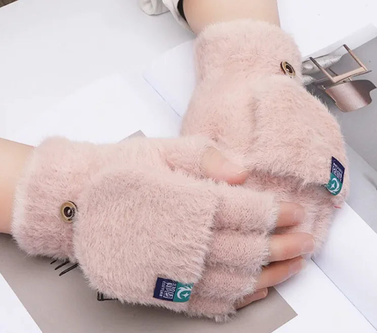 Female fingers flip winter gloves